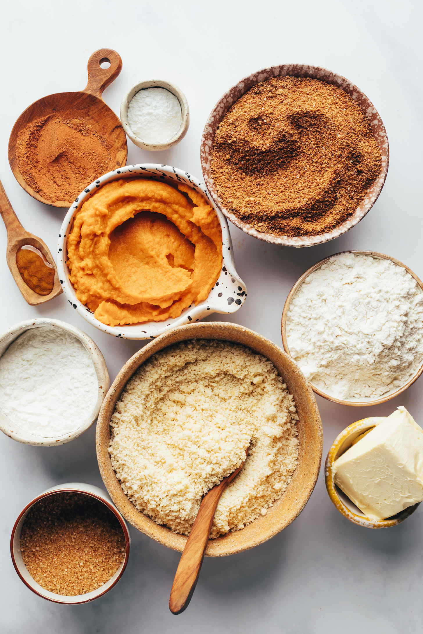 Pumpkin pie spice, baking powder, coconut sugar, pumpkin purée, cornstarch, cane sugar, almond flour, vegan butter, and gluten-free flour blend