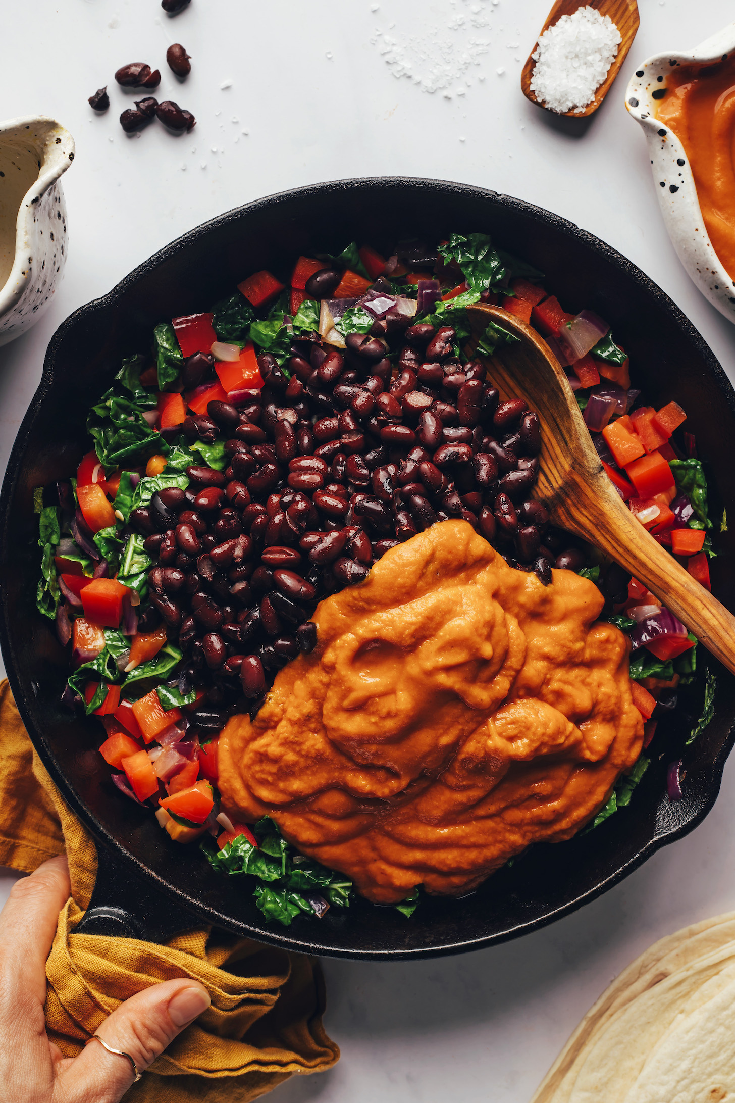 Black beans and pumpkin enchilada sauce over sautéed veggies