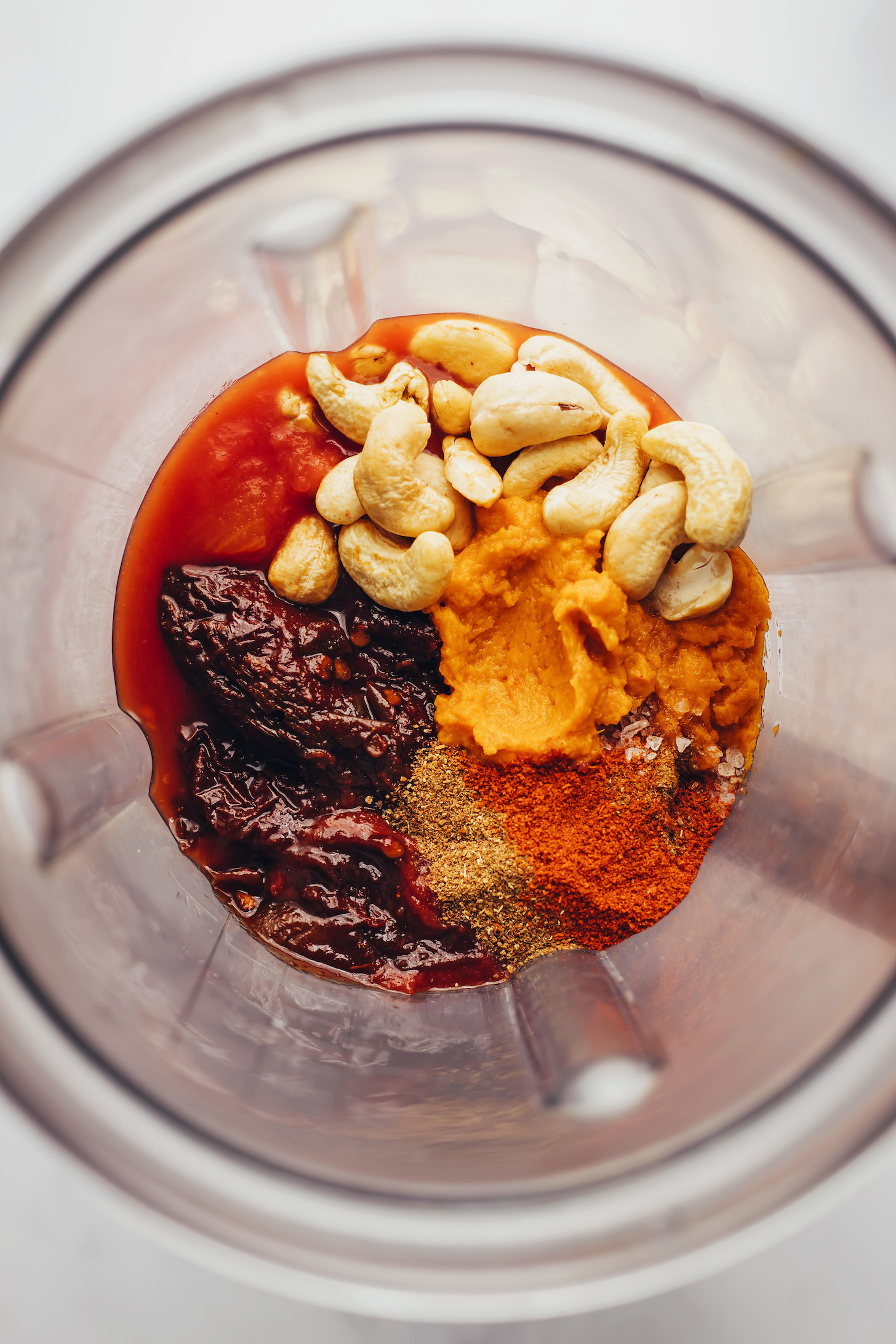 Blender with cashews, chipotle peppers, fire-roasted tomatoes, spices, and pumpkin purée