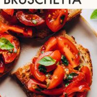Platter of vegan bruschetta with the recipe title written at the top of the image
