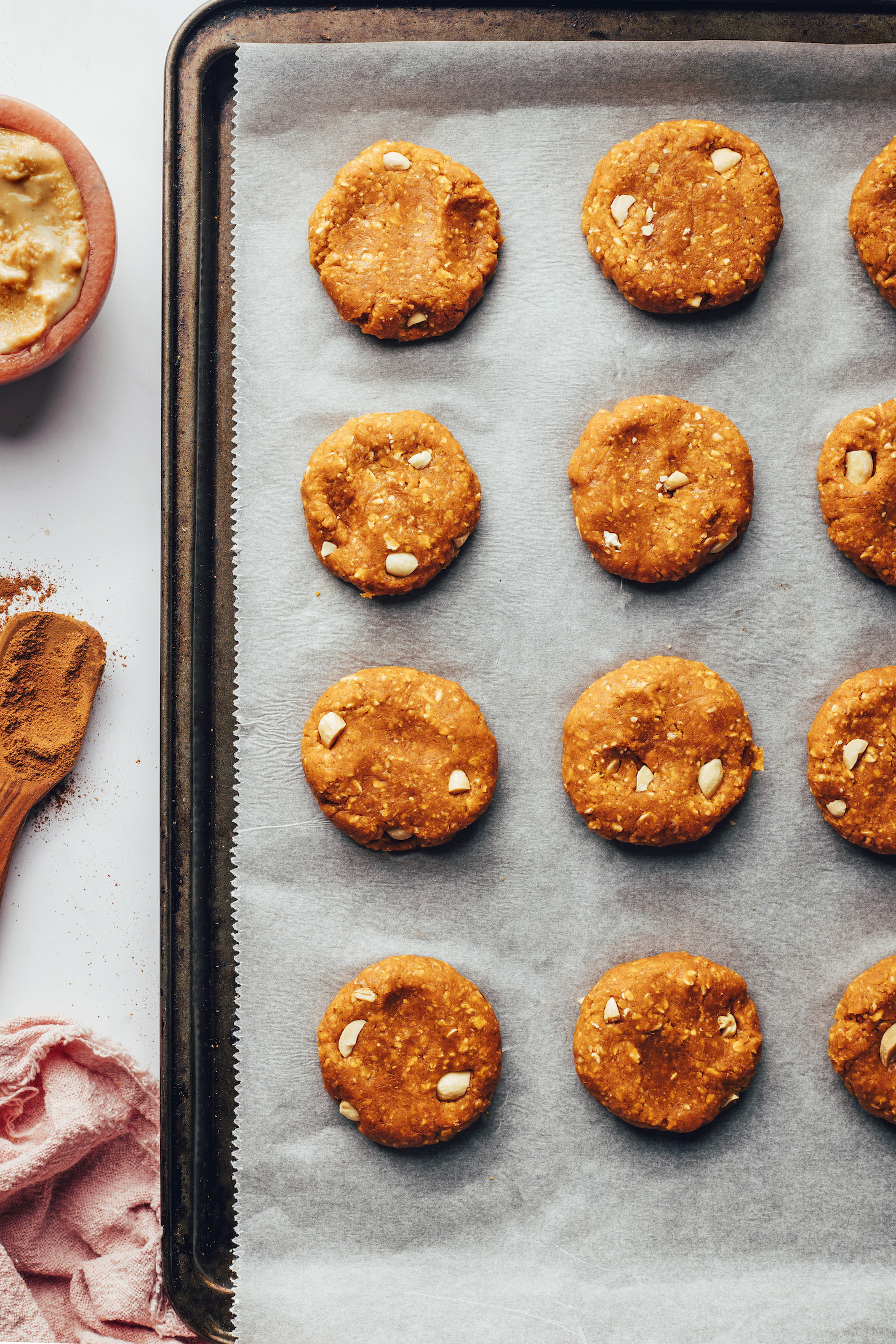 Unbaked breakfast cookies on a parchment-lined baking sheet