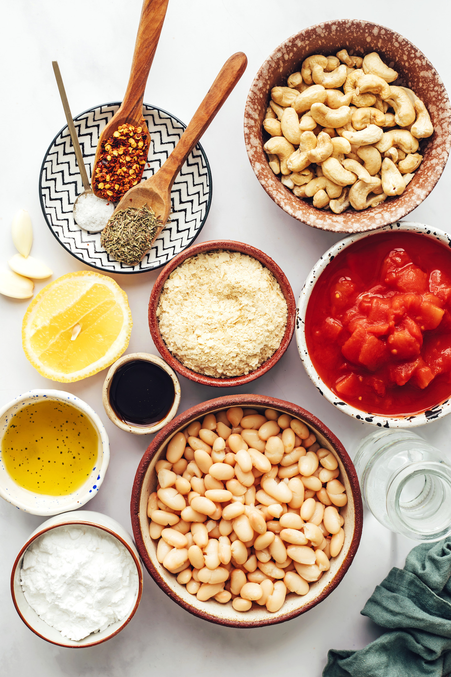Cashews, tomatoes, white beans, tapioca starch, olive oil, maple syrup, lemon, nutritional yeast, dried Italian herbs, garlic, salt, and red pepper flakes