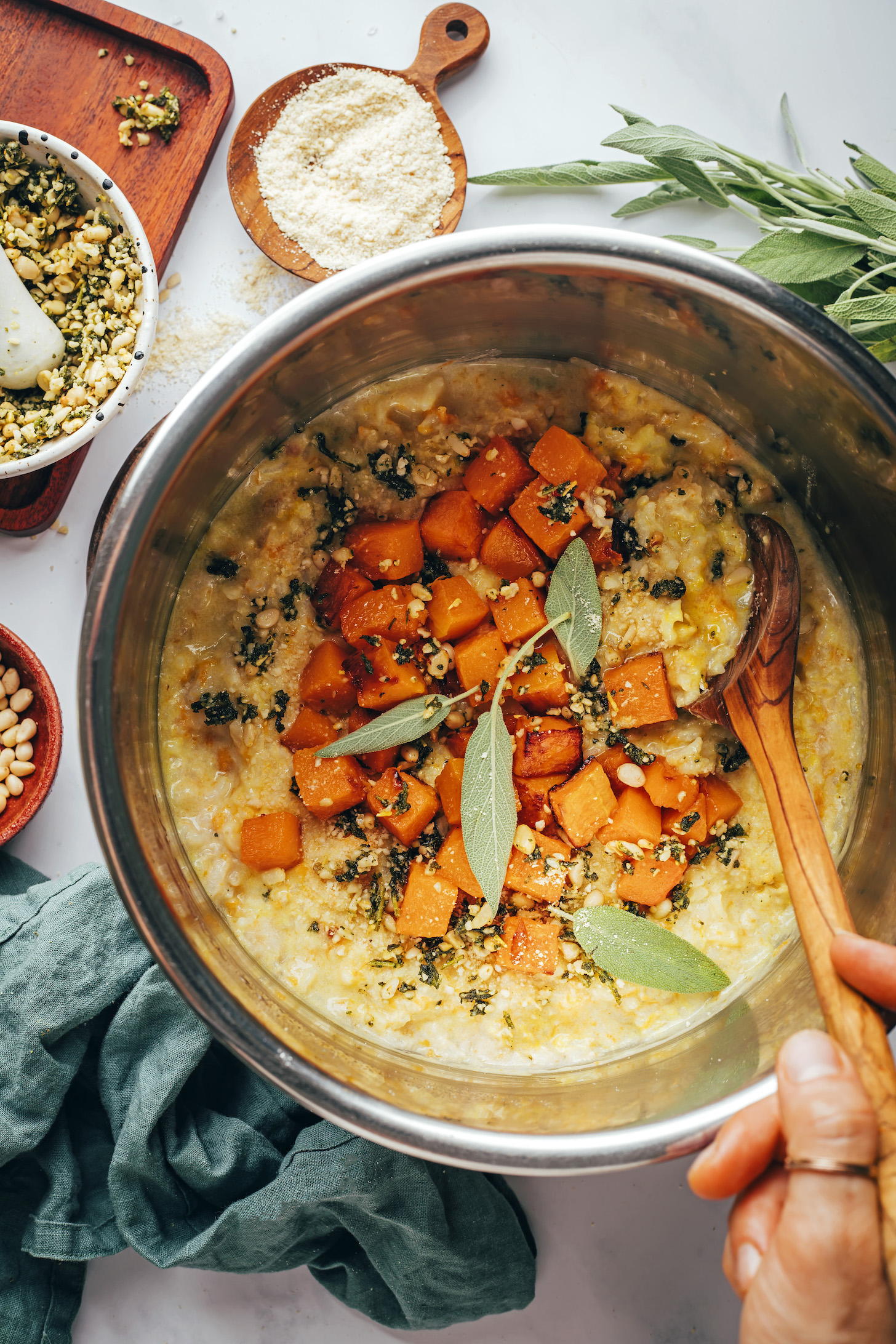 Cubed butternut squash and pine nut sage topping in an Instant Pot over risotto