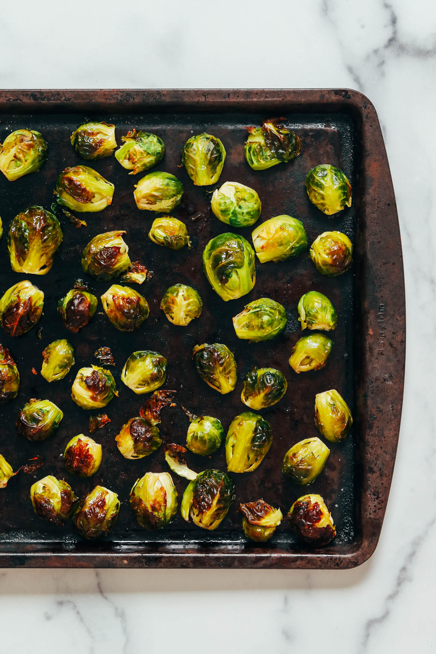 Crispy roasted Brussels sprouts on a baking sheet