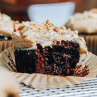 Showing the inside texture of a chocolate cupcake topped with peanut butter frosting