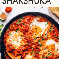 Easy 1-Pot Shakshuka with fresh or canned tomatoes written above a pan of shakshuka