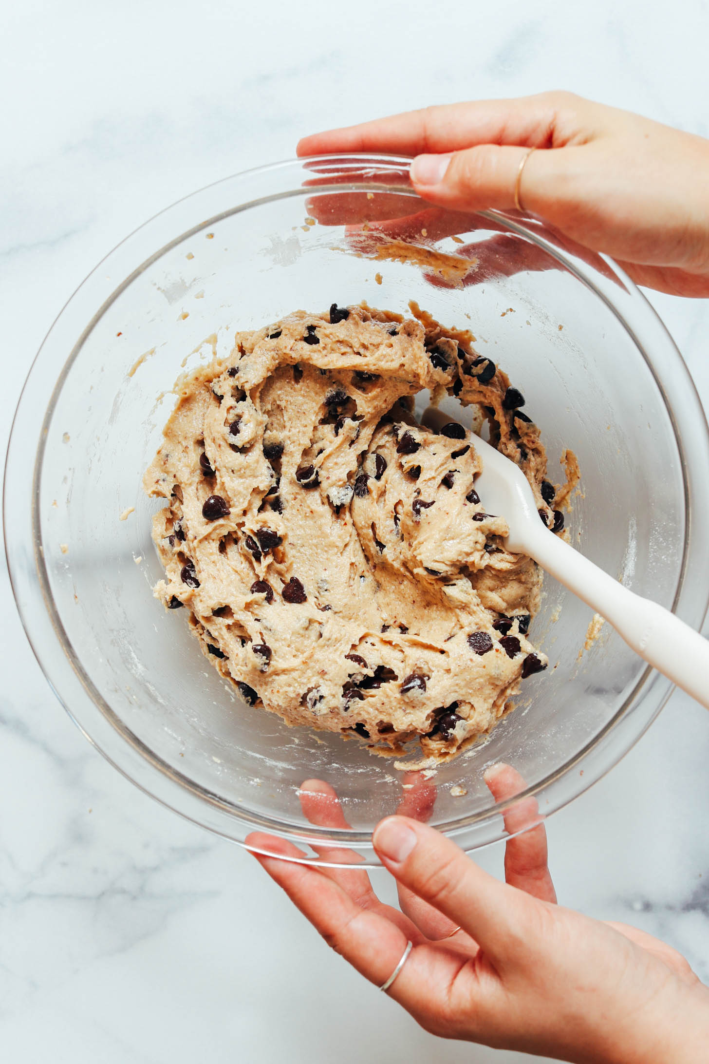 Silicone spatula in a bowl of  chocolate chip cookie dough 