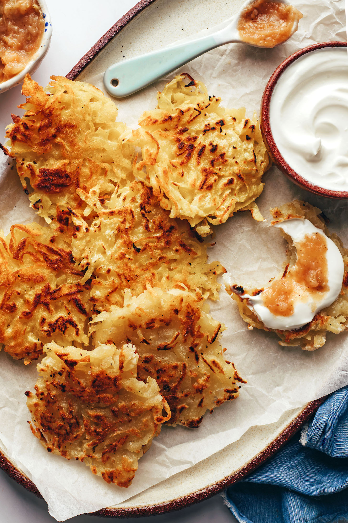 Plate of latkes with vegan sour cream and applesauce