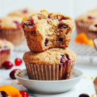 Close up shot of two cranberry orange muffins on a plate