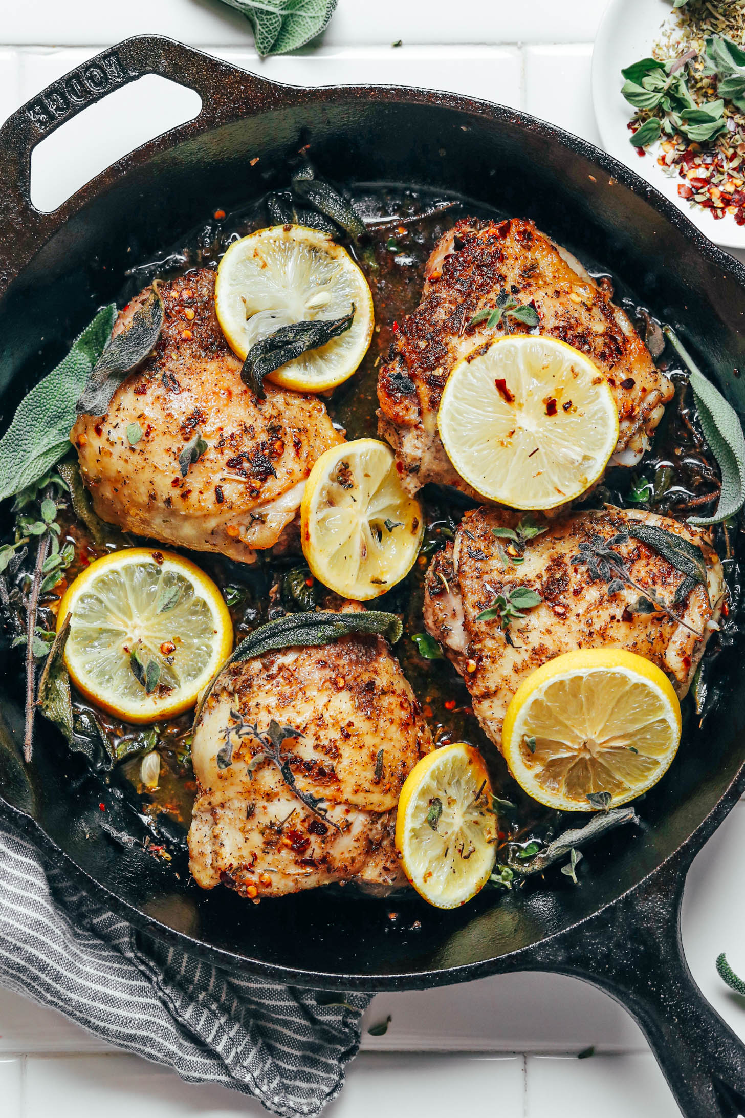 Cast iron skillet of our easy chicken thighs with lemon and herbs