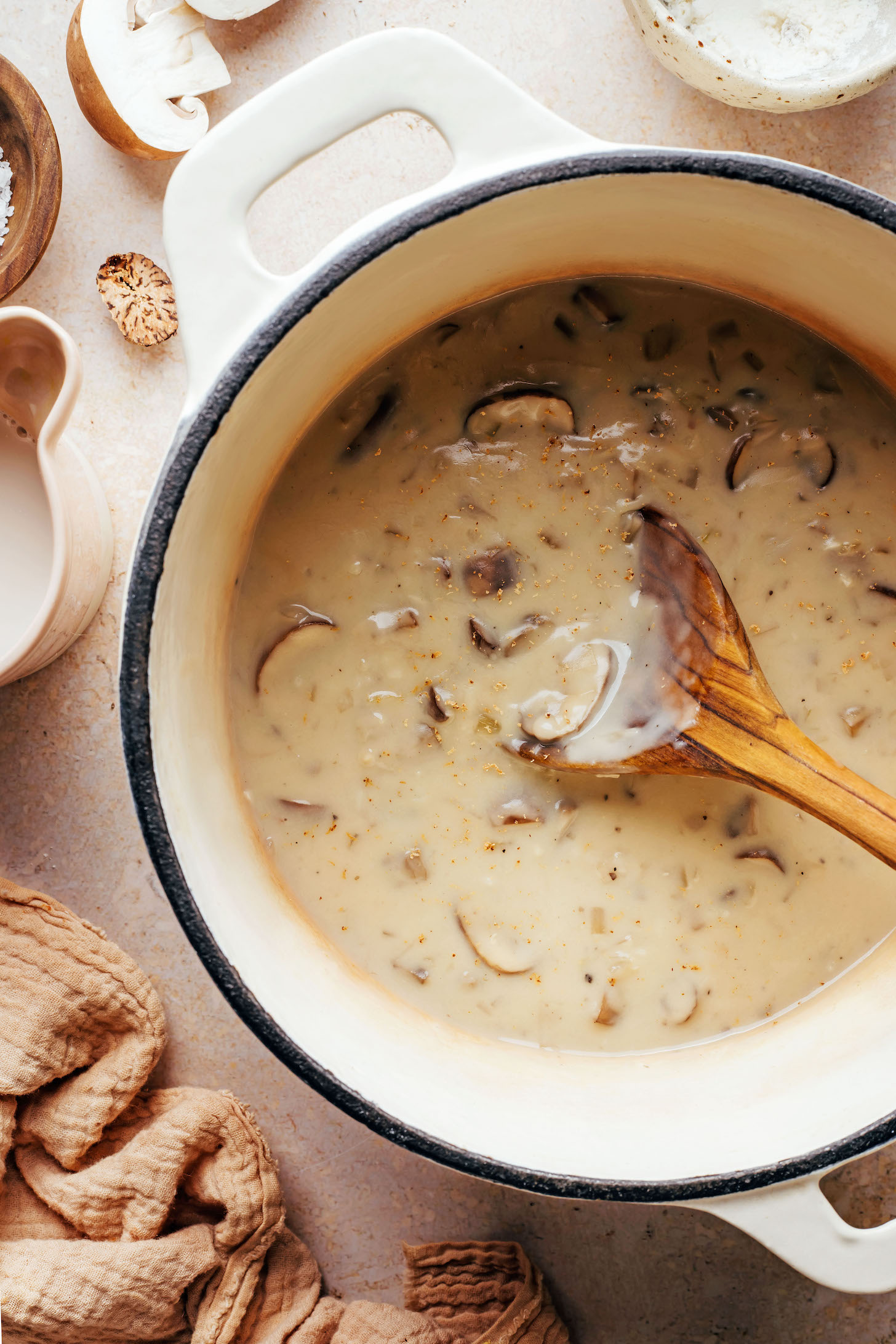 Nutmeg sprinkled on top of a pot of vegan gluten-free cream of mushroom soup