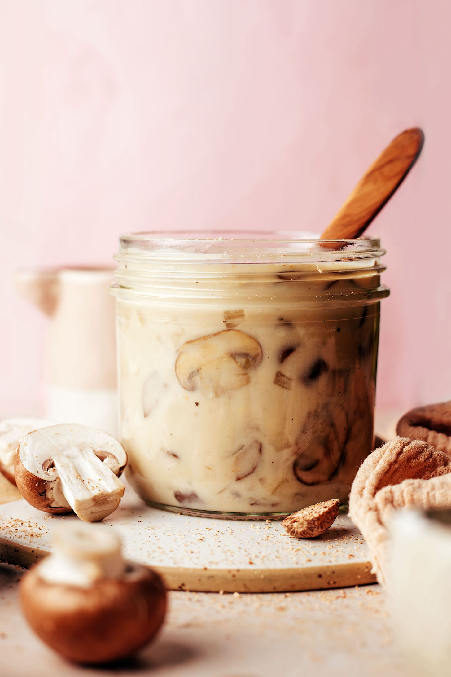 Small wooden spoon in a jar of homemade vegan gluten-free cream of mushroom soup