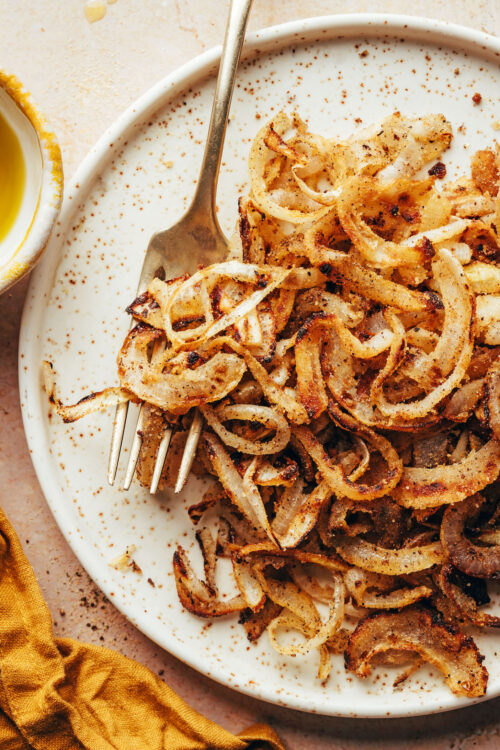 Fork on a plate of homemade gluten-free fried onions