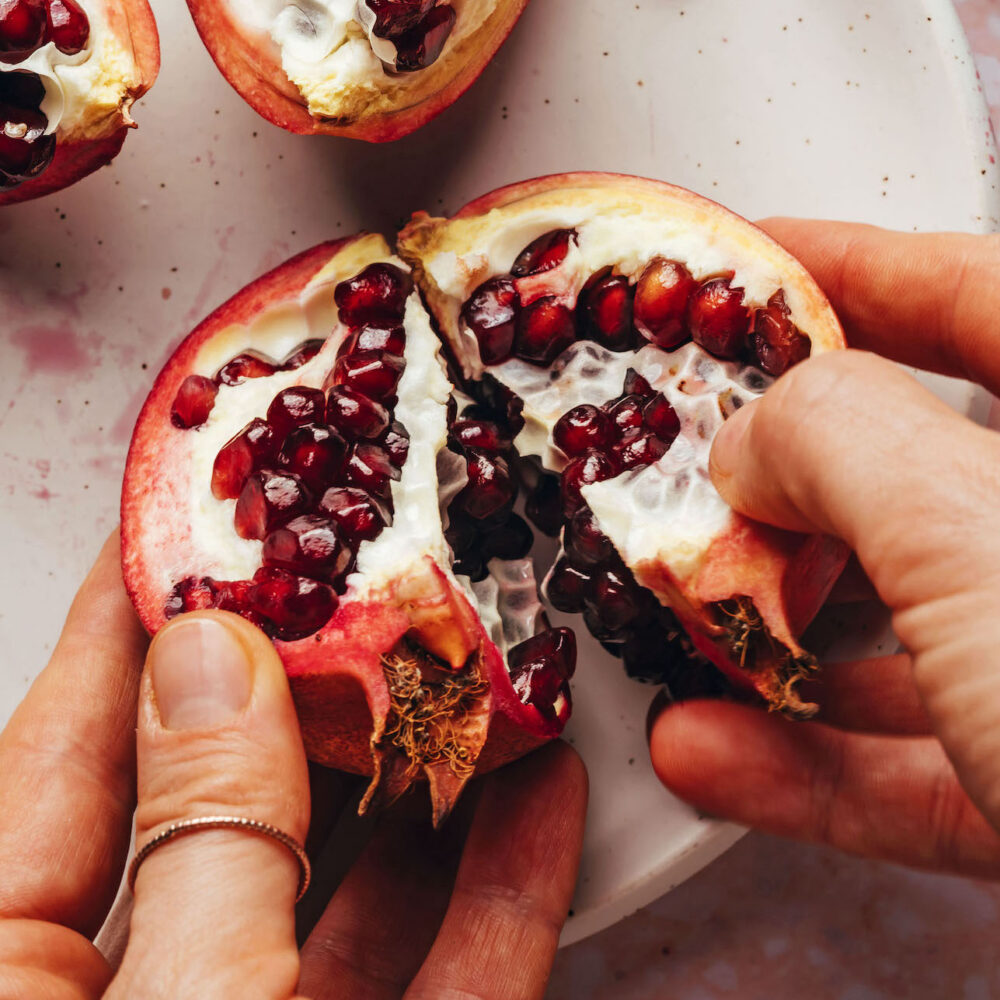 Breaking open a pomegranate to show how to get the seeds out