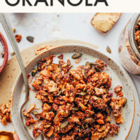 Vegan and gluten-free chai-spiced granola written above a bowl of granola with almond milk