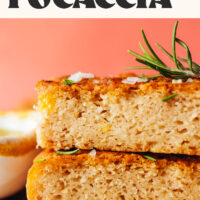 Two slices of focaccia topped with flaky salt and rosemary with text above it saying fluffy gluten-free focaccia just 10 ingredients