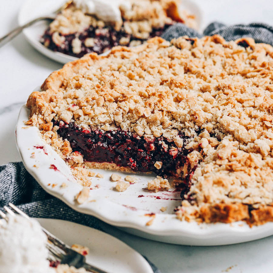 Close up shot of a plate and pie pan of our gluten-free berry pie recipe