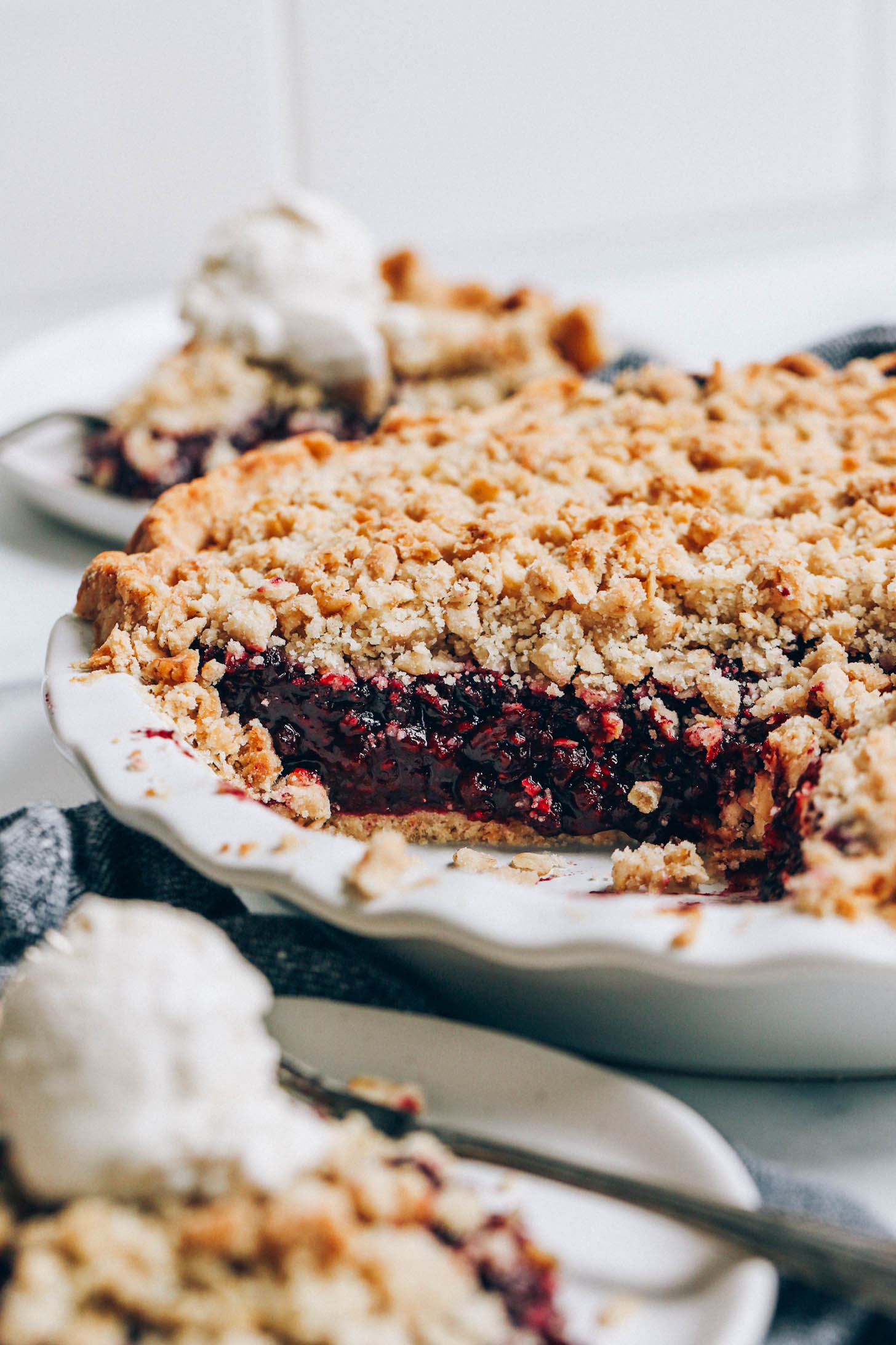Close up shot showing the jammy center of our mixed berry crumble pie