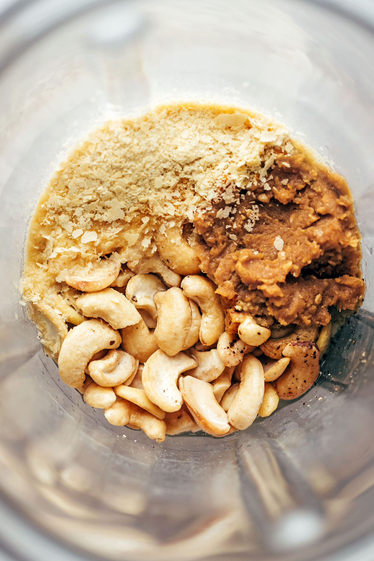Cashews, nutritional yeast, and miso paste in a blender