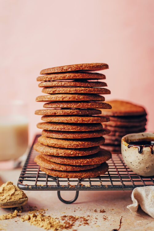 Stack of crispy gluten-free gingersnaps on a cooling rack