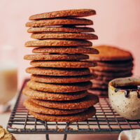 Stack of vegan gluten-free gingersnap cookies on a cooling rack