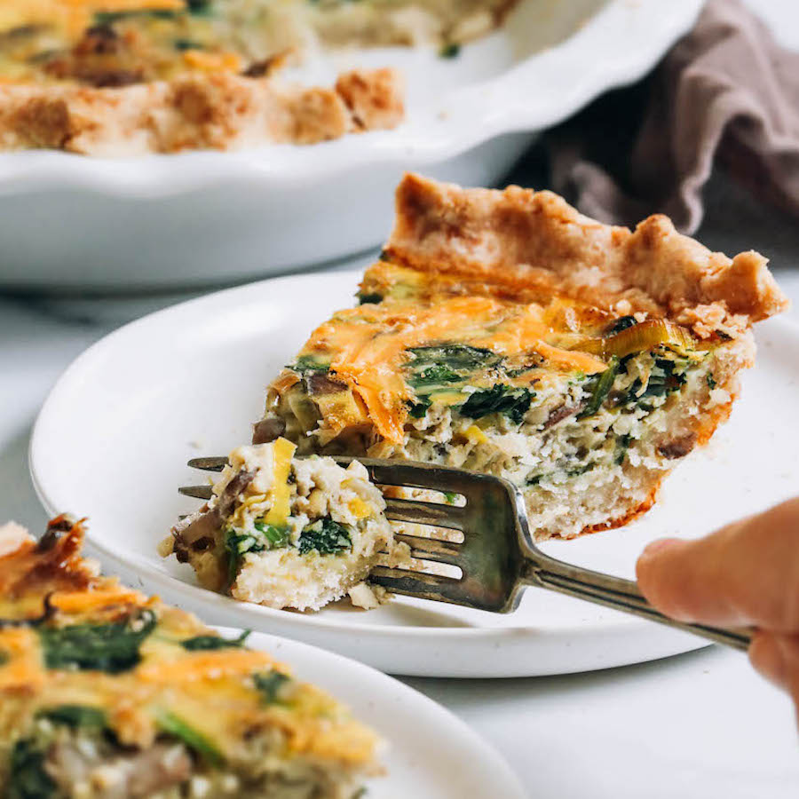 Using a fork to cut into a slice of gluten-free dairy-free quiche