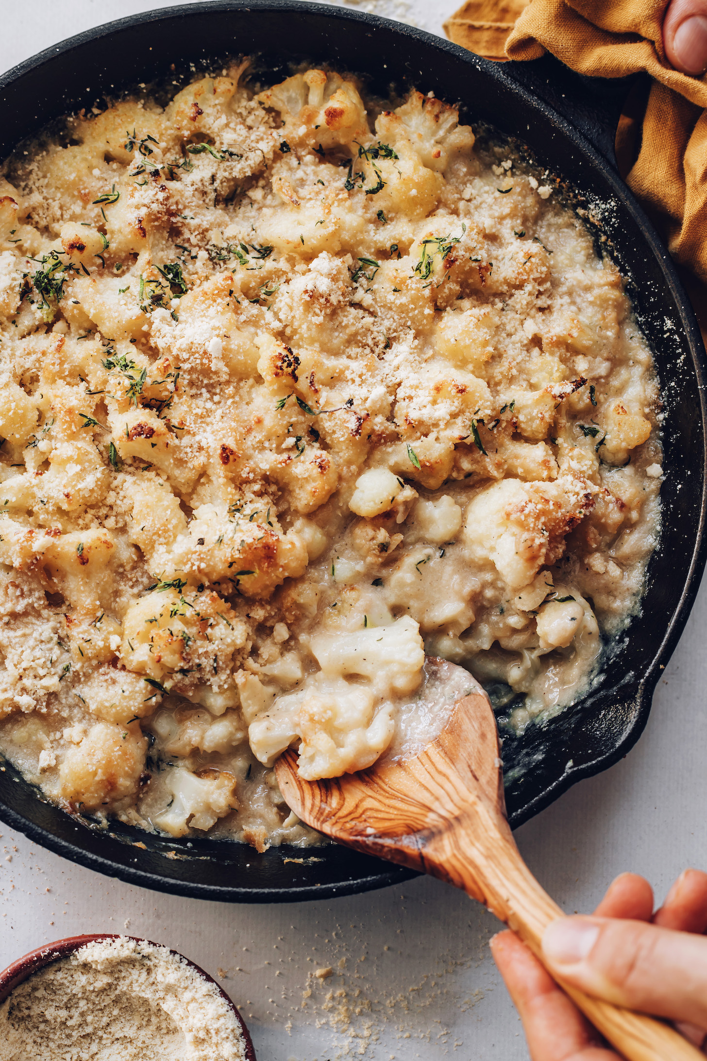Homemade breadcrumbs on a pan of cauliflower gratin