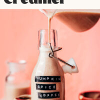 Text that reads 5 minutes and dairy free pumpkin spice coffee creamer above an image of pouring the creamer into a jar