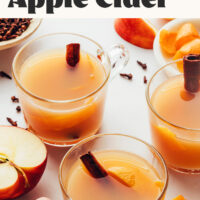 Two glasses filled with hot spiced apple cider
