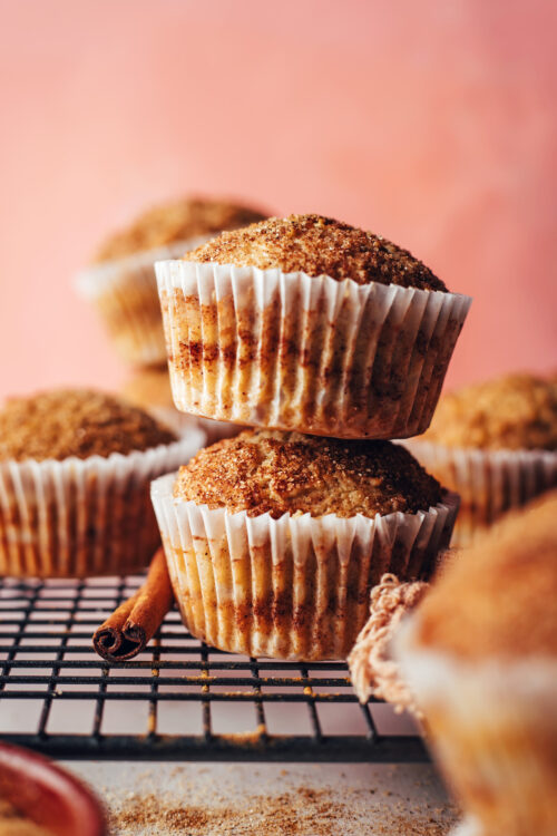 Stack of two vegan and gluten-free cinnamon muffins in cupcake liners