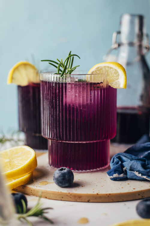 Glasses of our blueberry mocktail recipe with rosemary and lemon