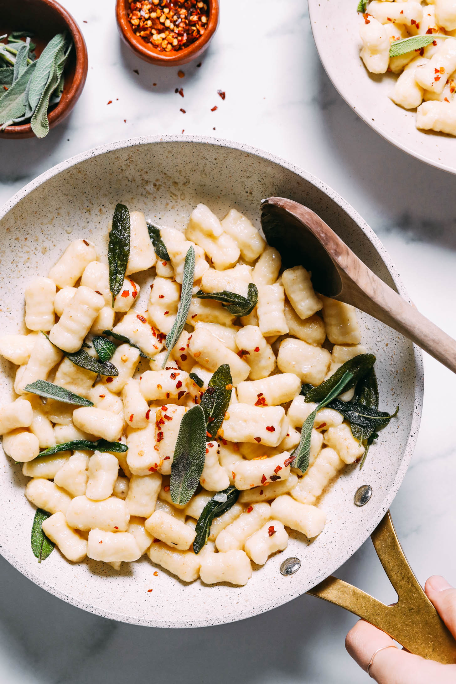 Skillet of gluten-free gnocchi with red pepper flakes and sage