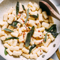 Skillet of gluten-free gnocchi with crispy sage and red pepper flakes