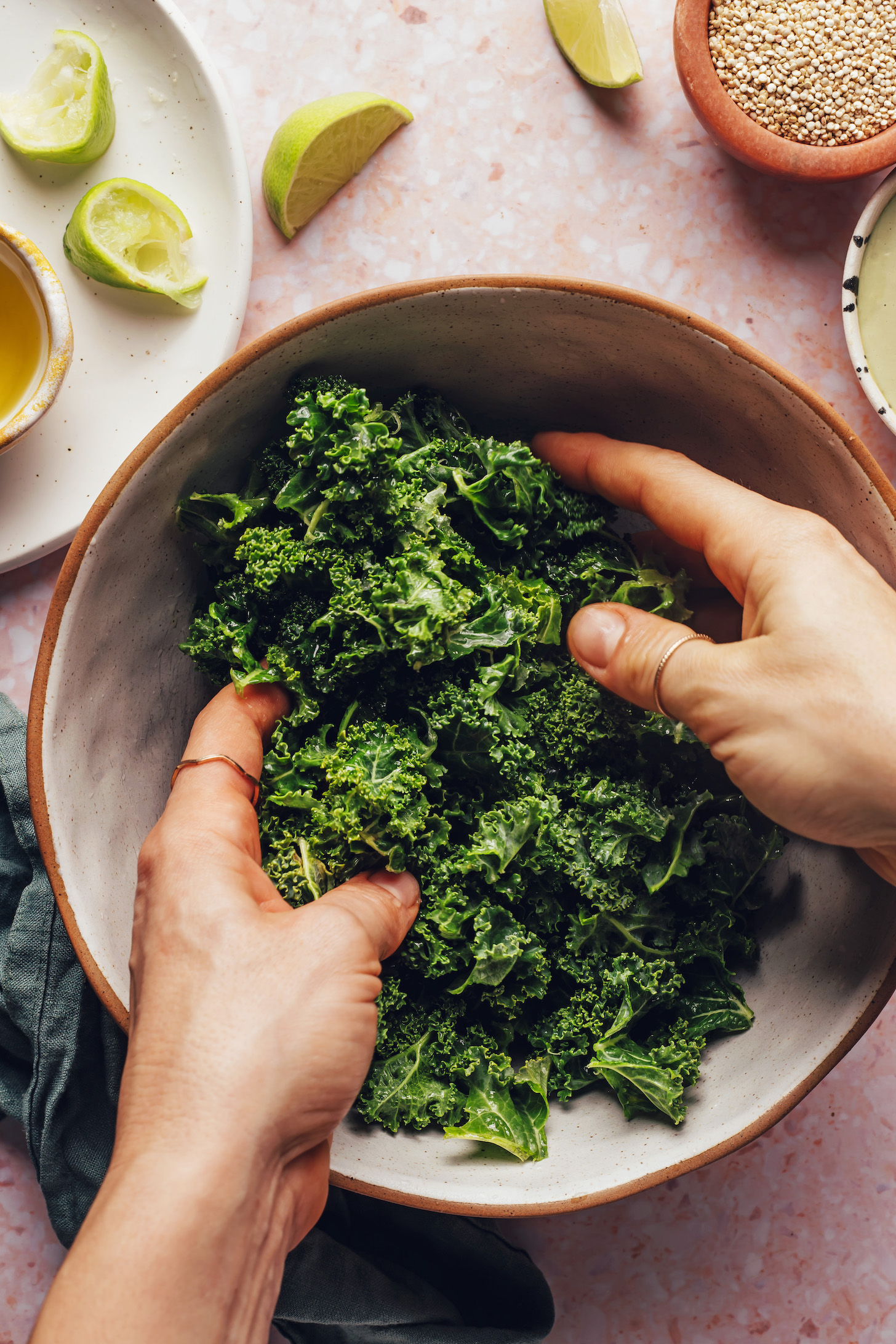 Massaging kale with lime juice, olive oil, and maple syrup