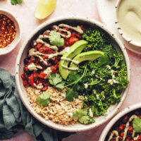 Vegan bowls with chili, quinoa, avocado, cashew jalapeno sauce, and massaged kale