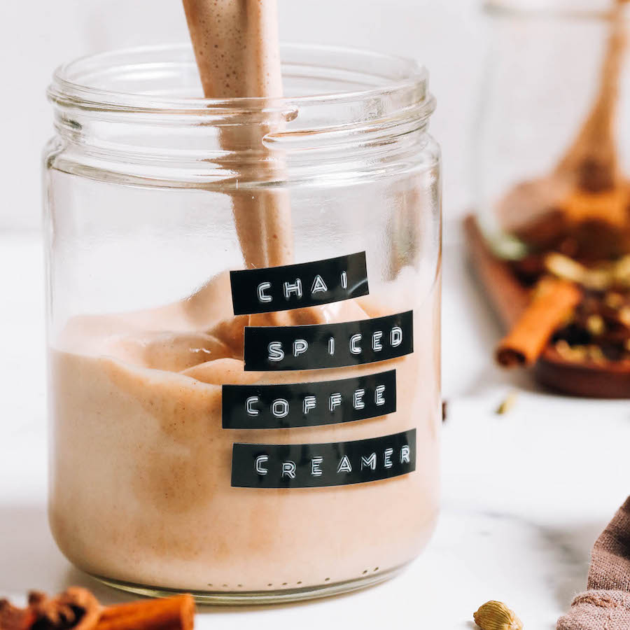 Pouring chai-spiced coffee creamer into a glass jar
