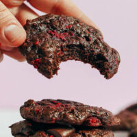 Hand holding a raspberry chocolate cake mix cookie