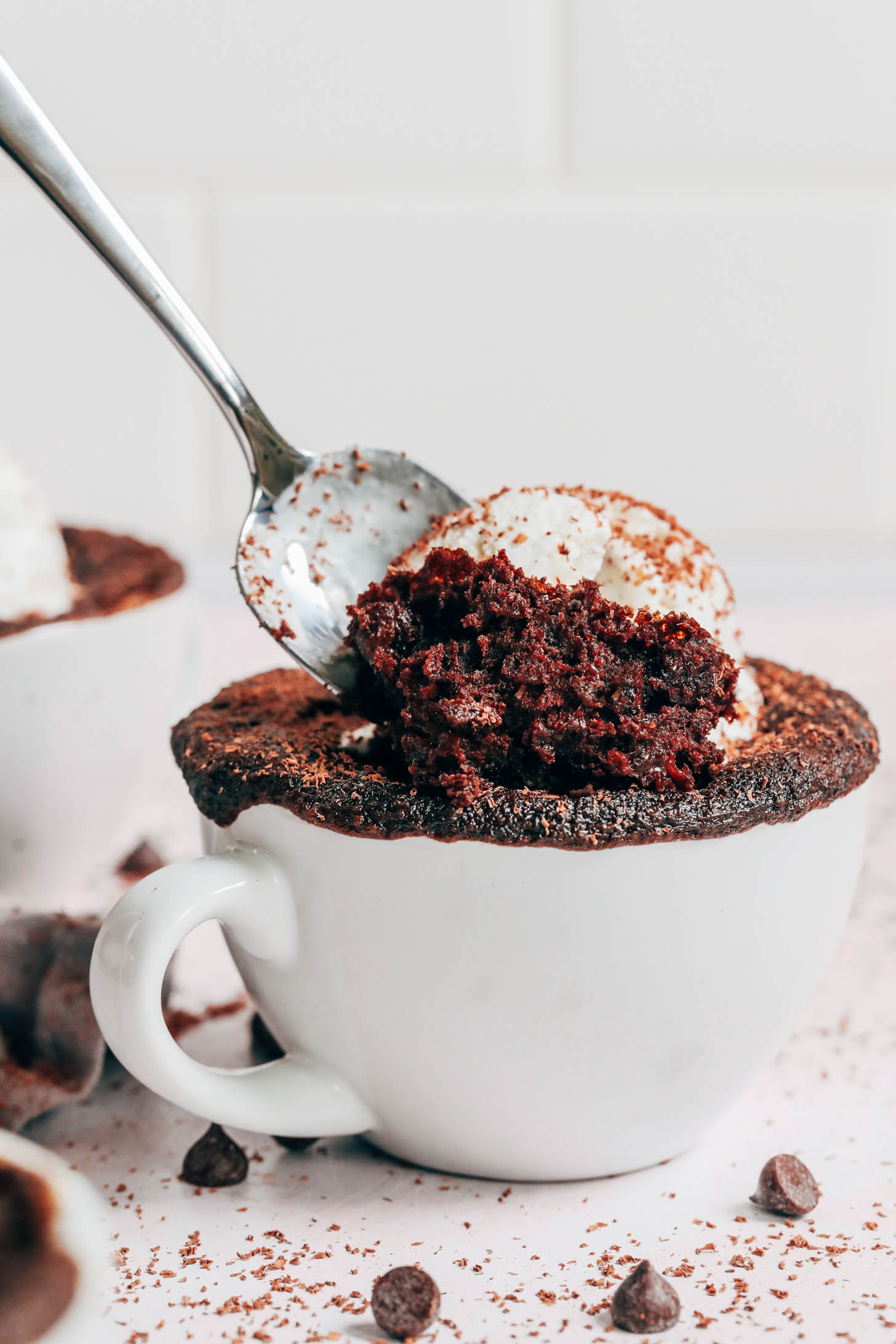 Scooping out a bite of gluten-free chocolate cake from a mug