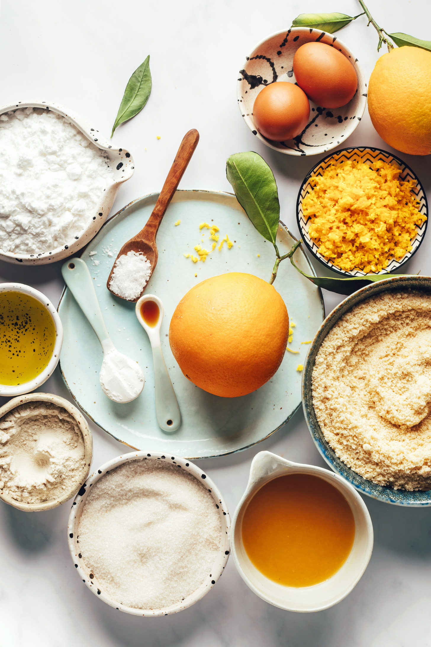 Eggs, orange zest, oranges, almond flour, orange juice, cane sugar, brown rice flour, olive oil, baking powder, salt, almond extract, and potato starch