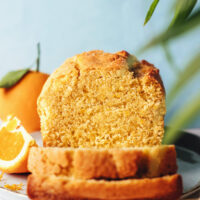 Partially sliced loaf of gluten-free orange almond cake