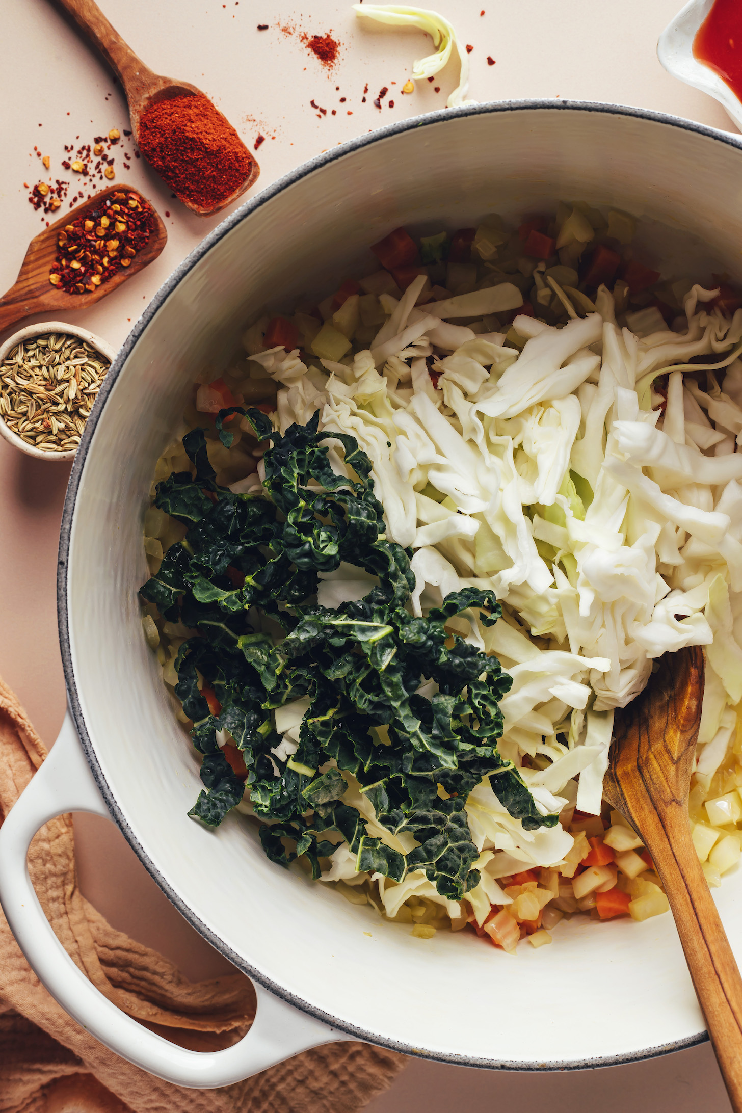 Top the roasted vegetables with shredded kale and cabbage