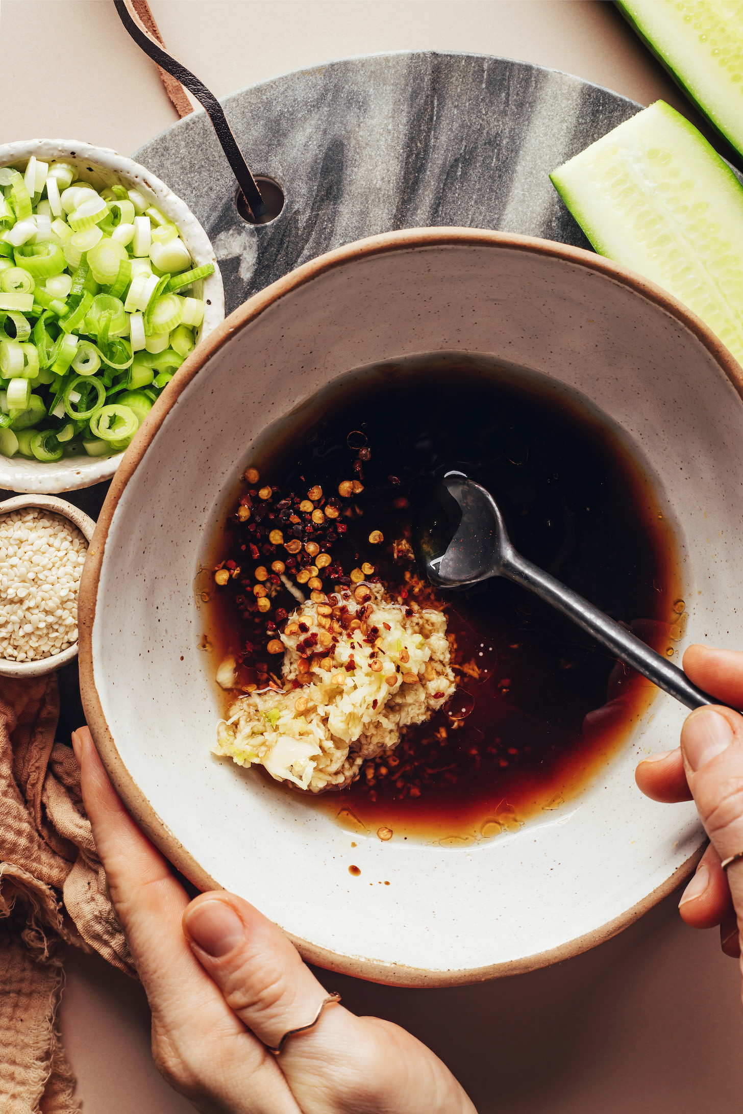 Stirring an Asian-inspired sesame ginger sauce in a bowl