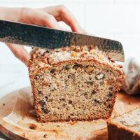 Slicing into a loaf of gluten-free dairy-free banana bread