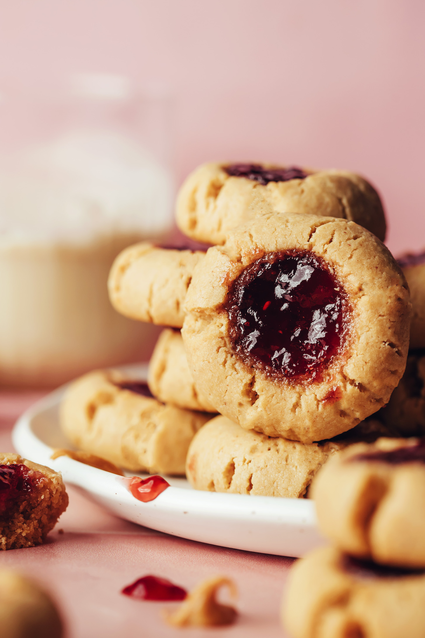 Stacks of vegan gluten-free peanut butter and jelly thumbprint cookies