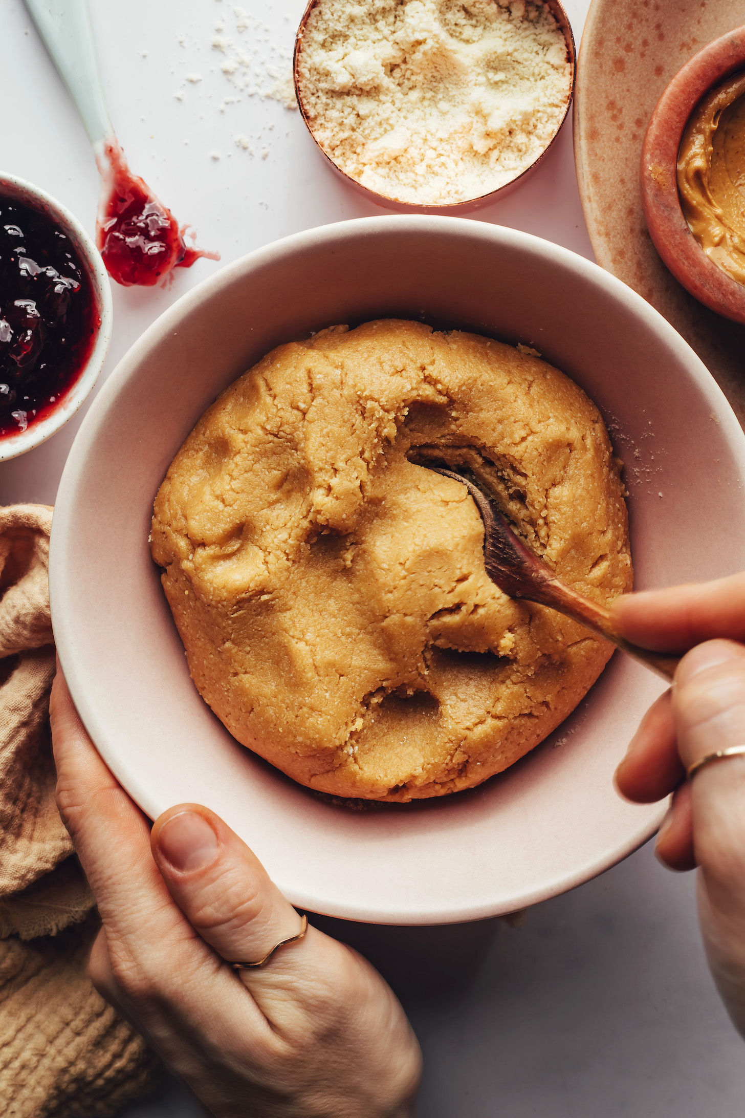 Spoon in a bowl of gluten-free peanut butter thumbprint cookie dough
