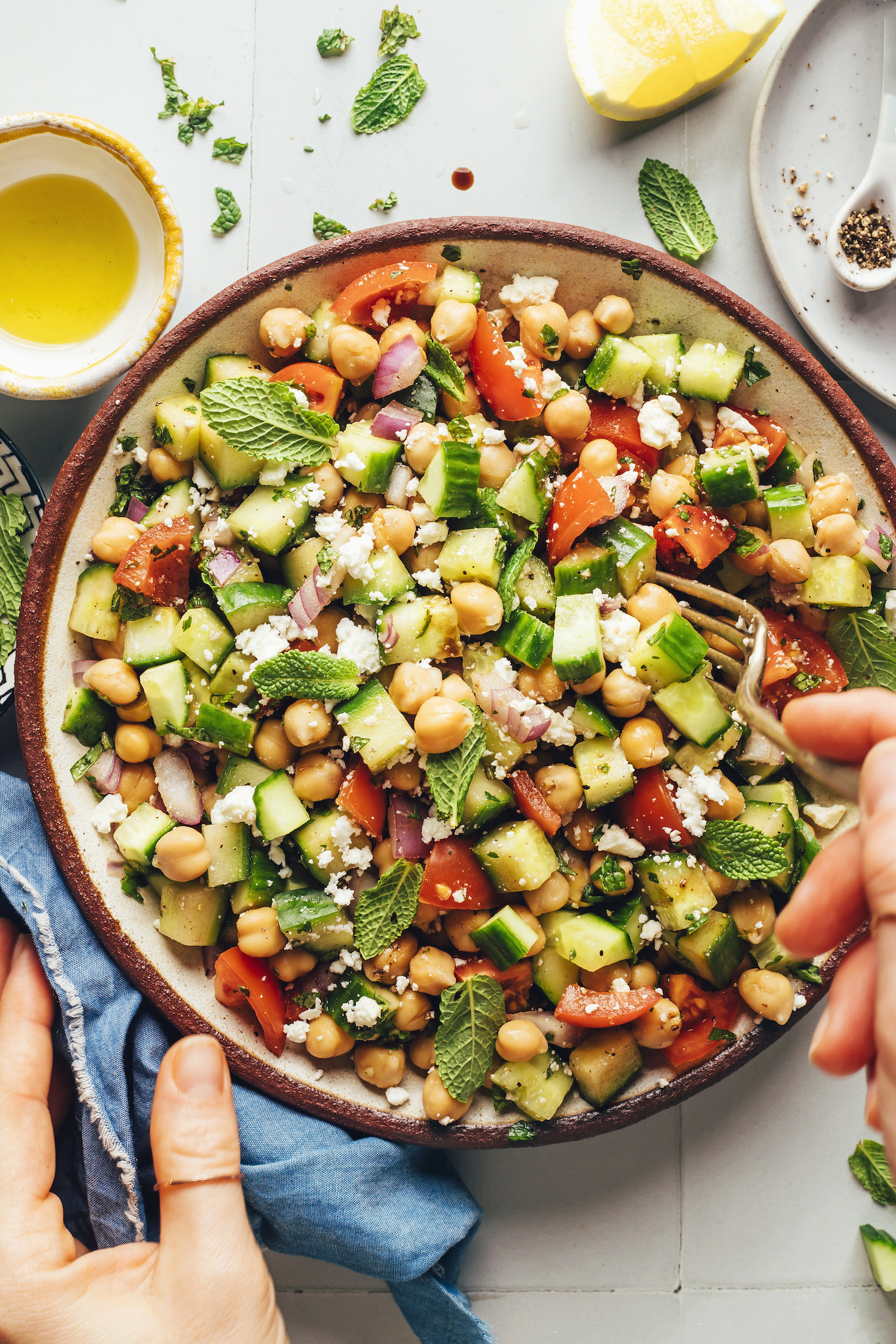 Using a fork to pick up a bite of Mediterranean cucumber chickpea salad