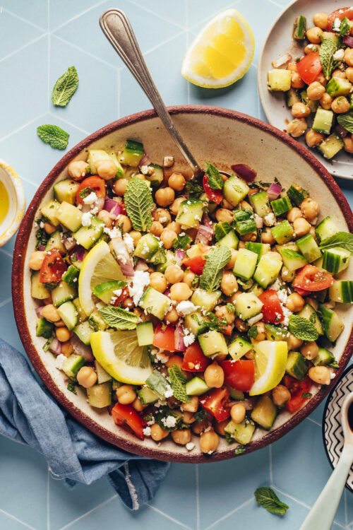 Overhead shot of two bowls of cucumber chickpea salad for our round-up of cucumber recipes