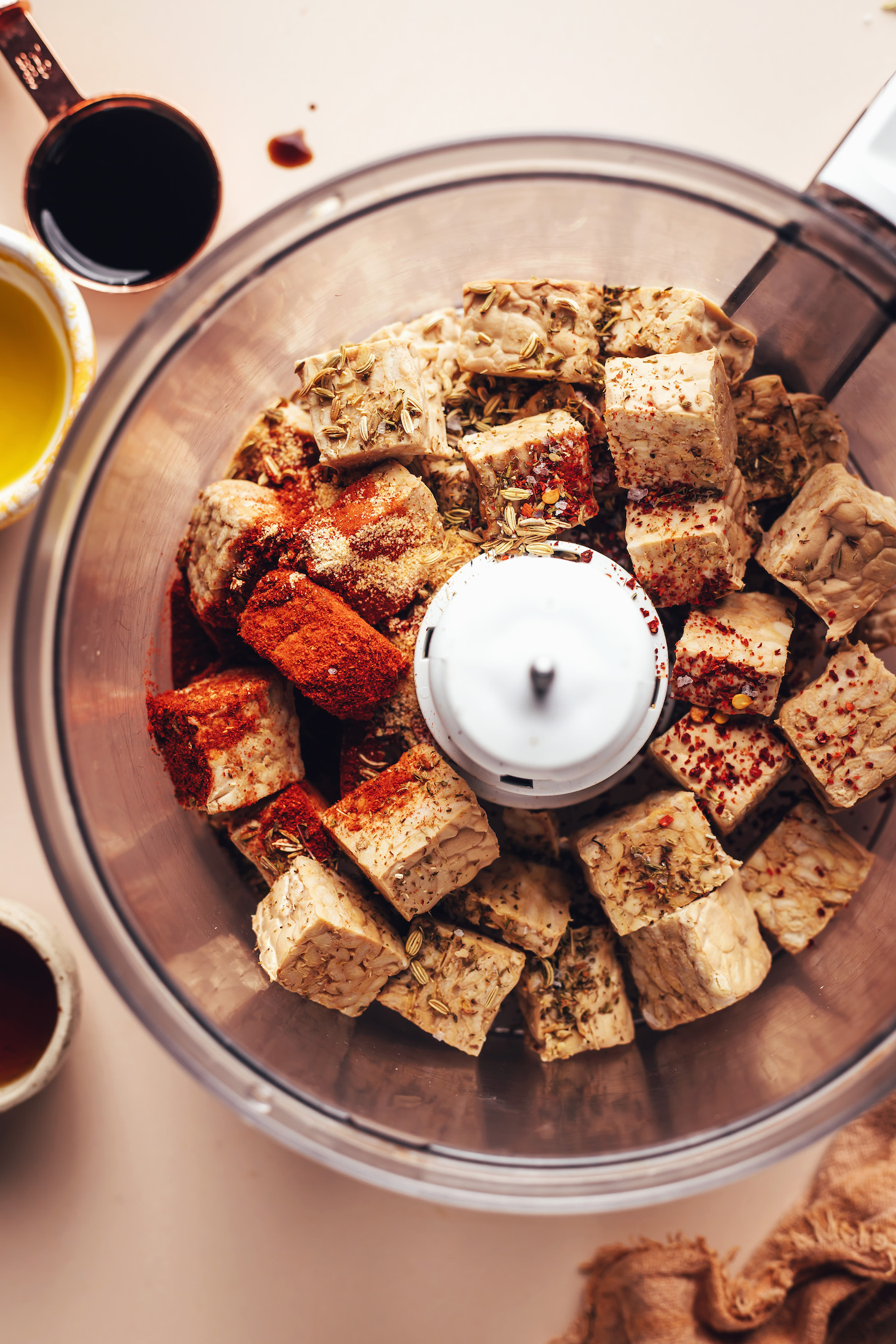 Food processor with cubed tempeh and spices