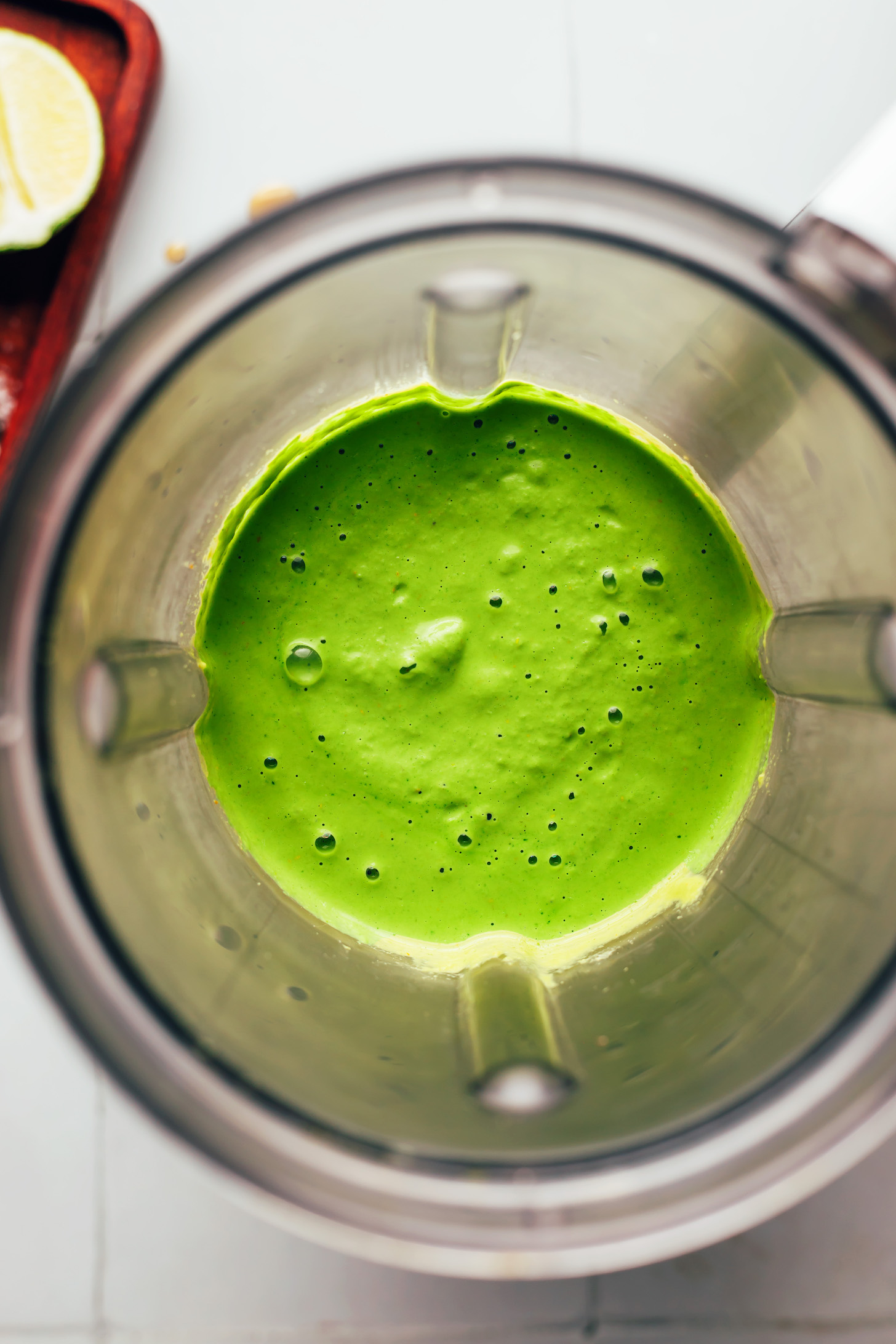 Vibrant green aji verde sauce in a blender
