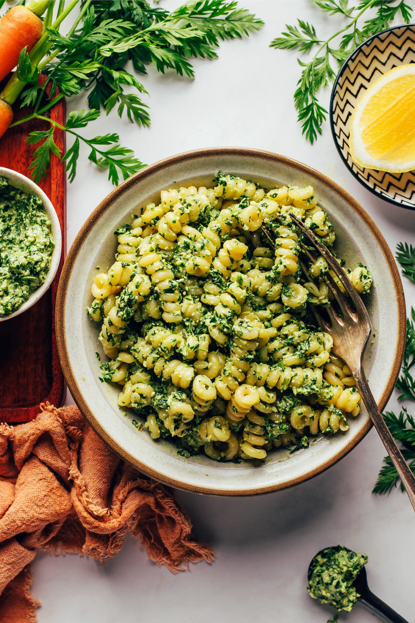 Bowl of pasta tossed with carrot top pesto